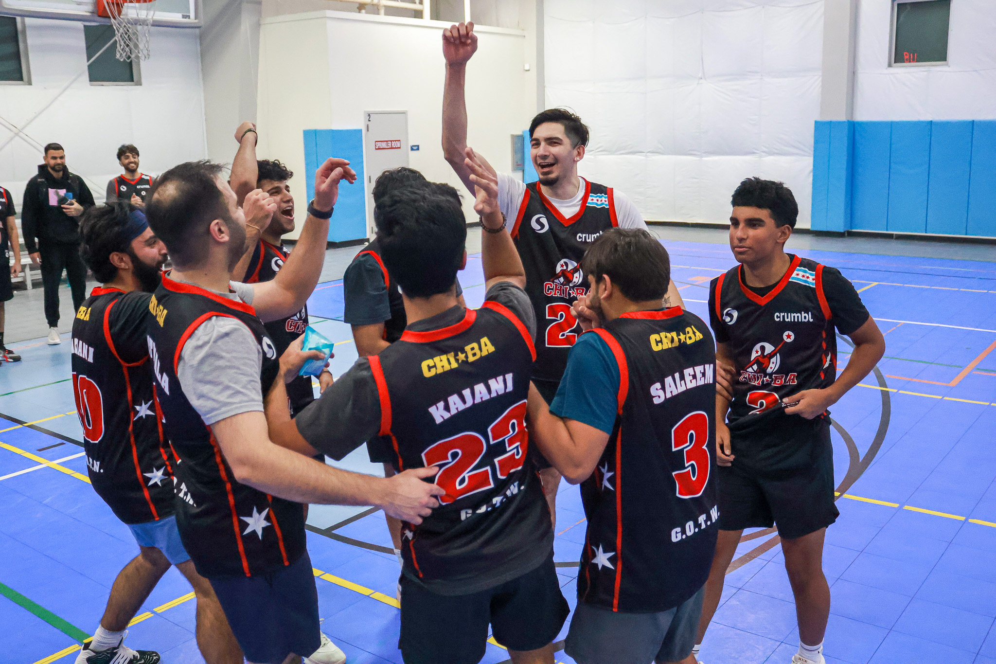 Basketball team celebrating black red uniforms